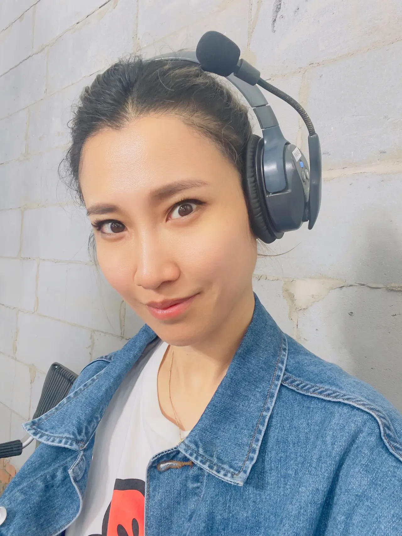 Camilla on set wearing a production headset